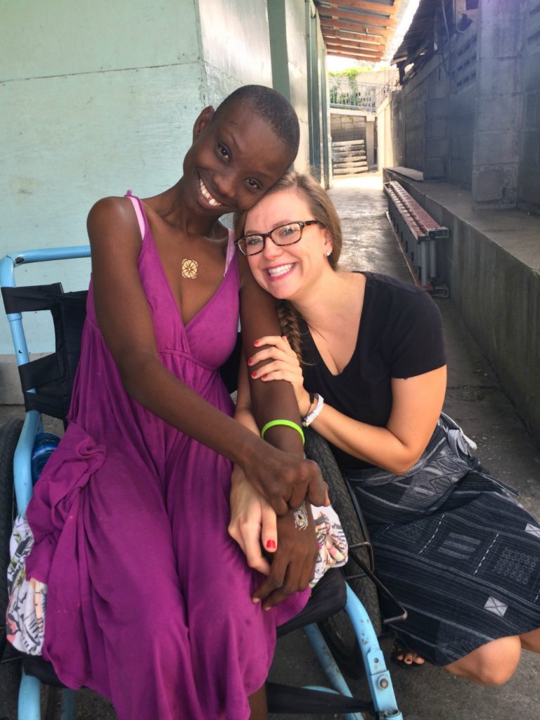 Volunteer pharmacist Brittany in Haiti embraces her Haitian friend.