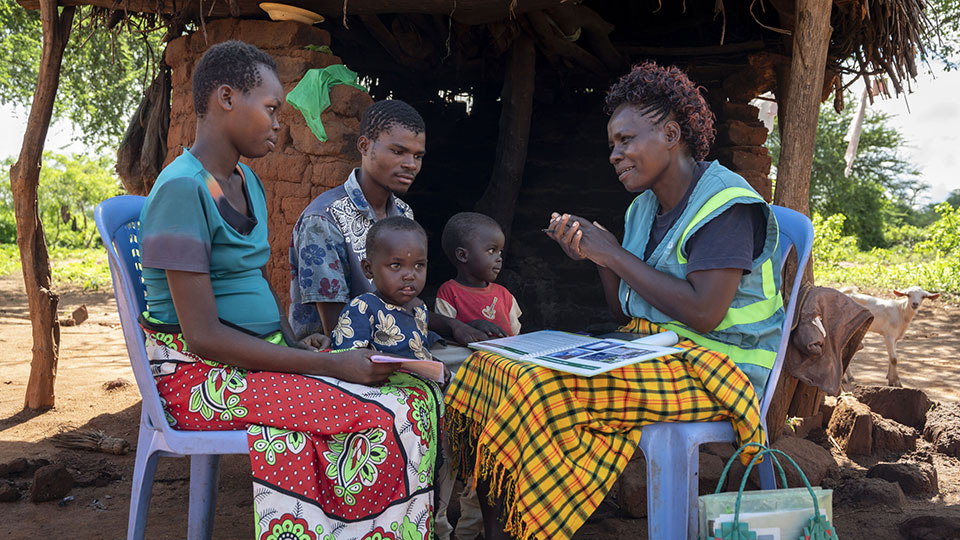 Community-health-worker-visits-with-family_CMMB-Kenya.