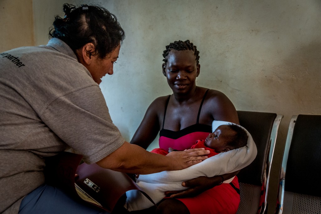 Dr. Rachael Consoli with a mother and her baby