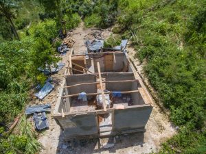 a home with no roof, windows or doors. Destroyed by hurricane.