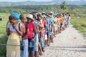 Hurricane in Haiti and a long line of people waiting for help
