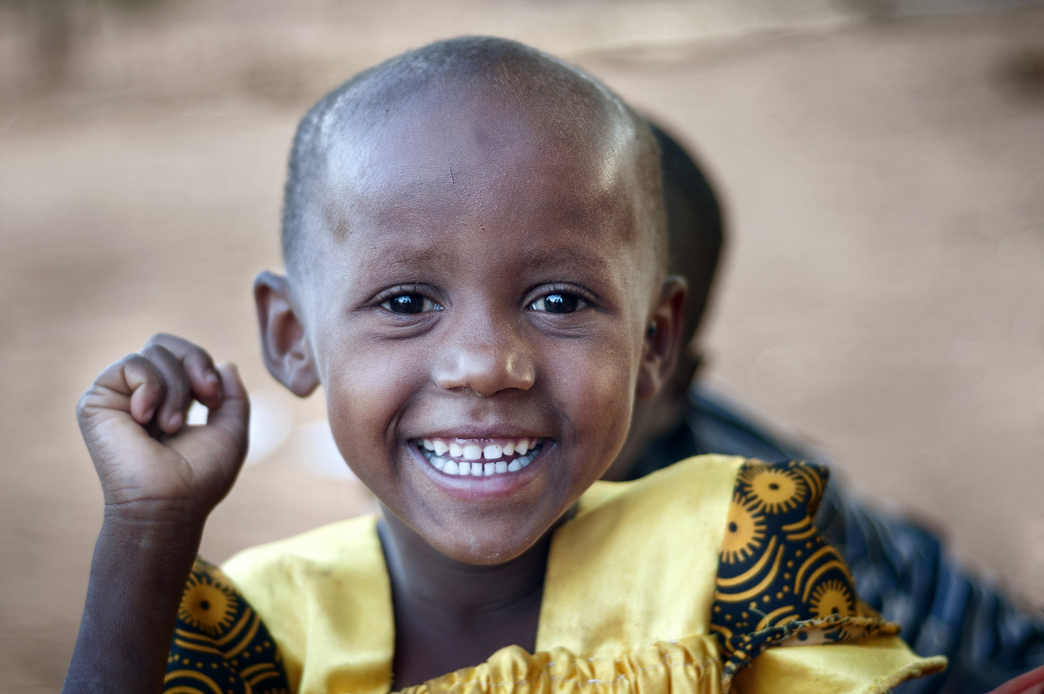 child in Kenya in a yellow dress