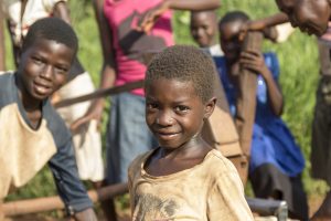 Boy at a water pump outside Nzara South Sudan