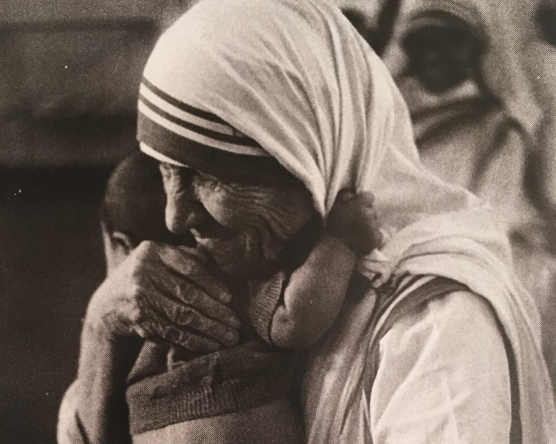 Mother teresa holds a baby in her arms. A speech about love.