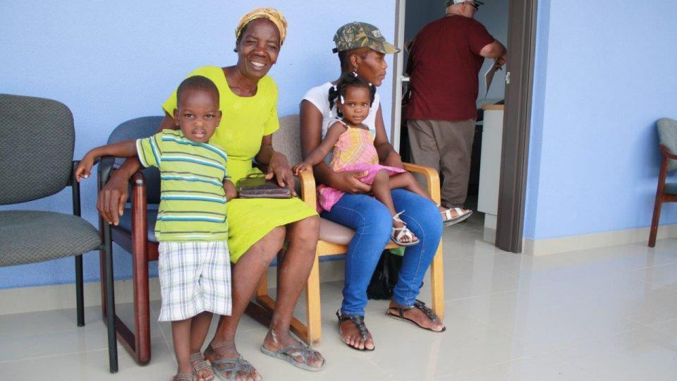 Several visitors wait to be seen with their children. at a new hospital in Haiti.
