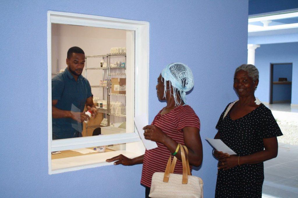 A pharmacist provides medication to residents in Haiti. 
