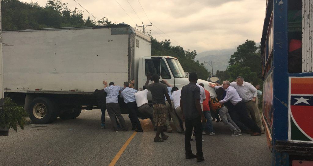 Everyone who travelled to Haiti for the dedication leaned into to give this truck a push