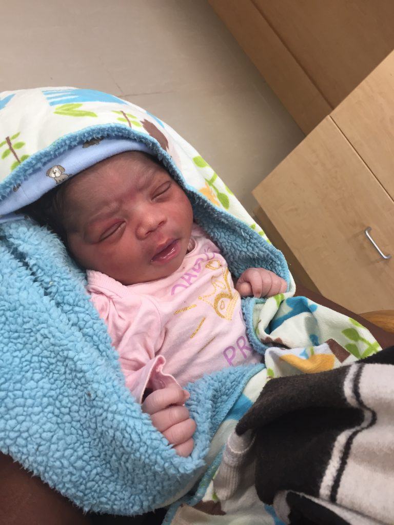 A premature baby in her mother's arms at the Bishop Joseph M. Sullivan Center for health, CMMB's Haiti Hospital Opening