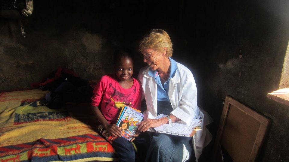 Long time CMMB volunteer, nurse Kathleen shares a moment with Thandazile