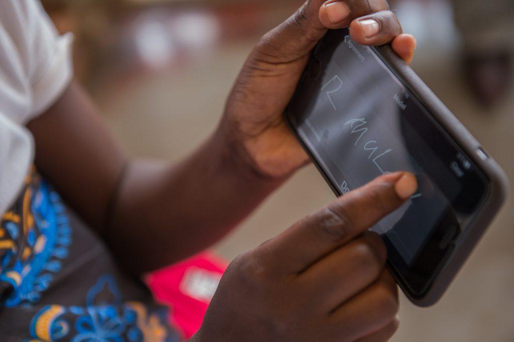 digital health Zambian woman using mobile phone