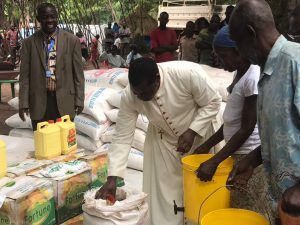 Bishop Eduardo at Rimenze overseeing the distribution of food.