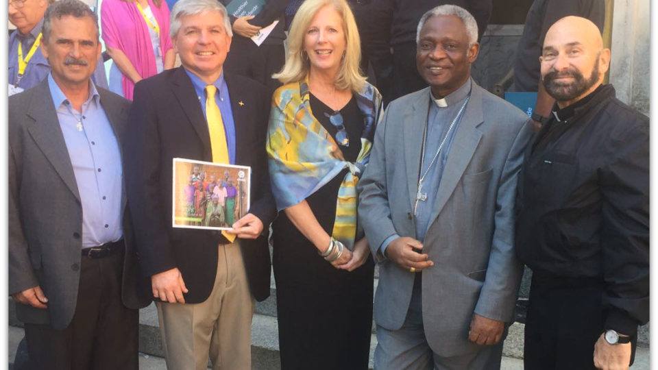 Feature Image Adrian Kerrigan, SVP Partnerships at CMMB with members of Cross International, Cardinal Turkson and Monsignor Tejeda