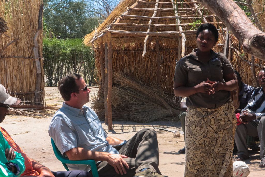John Starcher listens attentively to a community members in Mwandi Zambia.