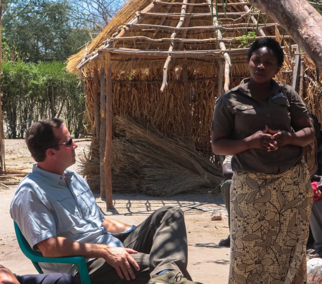 John Starcher listens attentively to a community members in Mwandi Zambia.