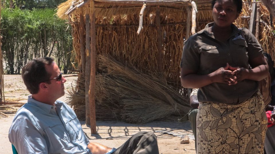 John Starcher listens attentively to a community members in Mwandi Zambia.