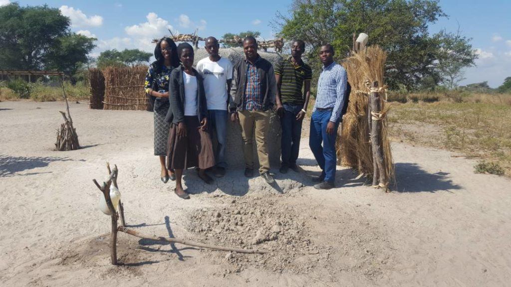 Janet stands with community WASH champions in Zambia