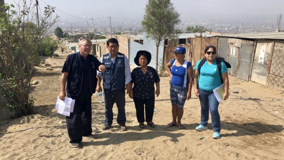 Nancy Castillo, Project Coordinator, and several healthcare workers and representatives from the Municipal Government, survey an area for the construction of an emergency health post.