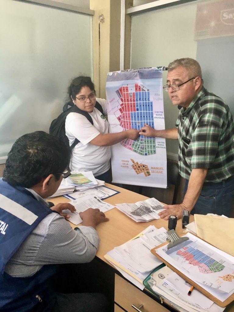 Nancy Castillo, Project Coordinator, and Dr. Morera, Director of the Bellavista Health Post, show a Municipal Government official a map of the zone currently without adequate healthcare services.