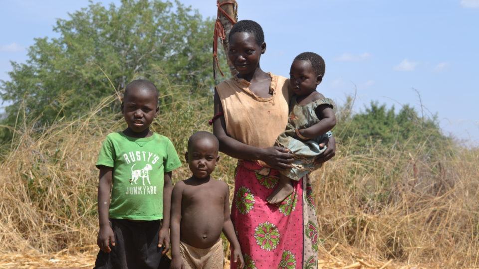 Muthania, mother and her children outside of their home in rural Kenya.