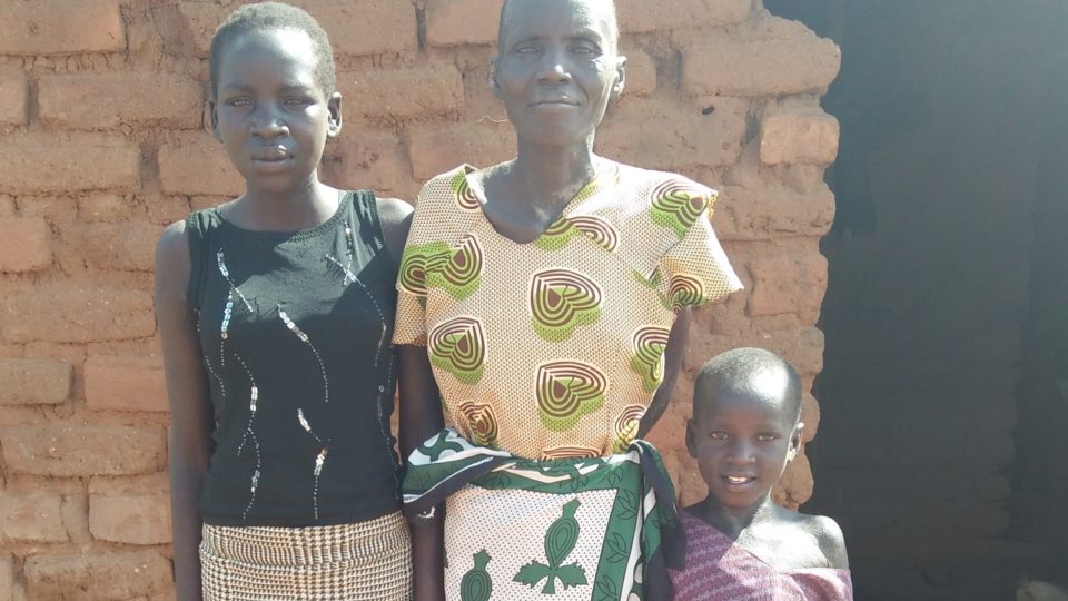 Lilian and her family in front of their home.