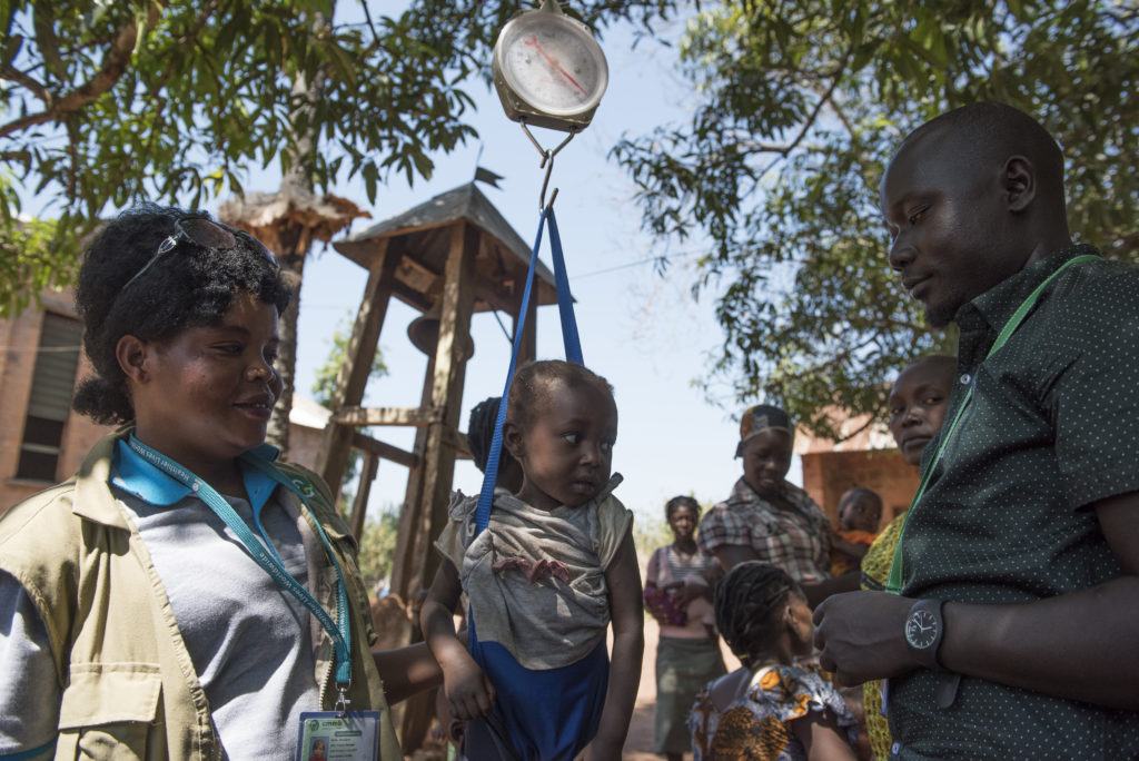 CMMB Staff screening a child for malnutrition in Rimenze.