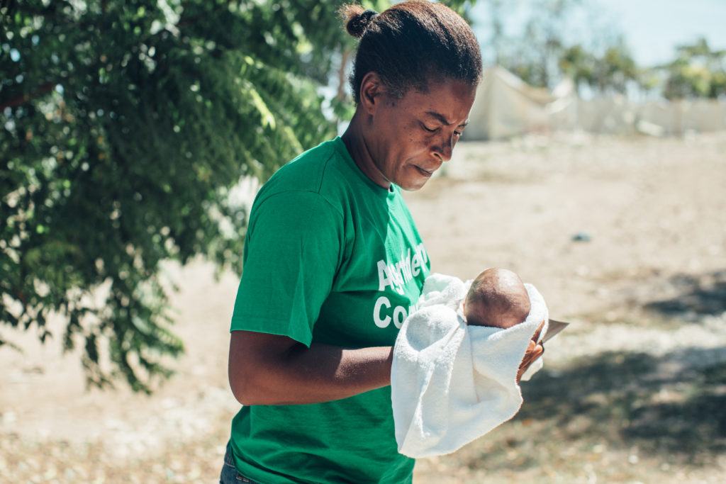 Kerna holding newborn baby