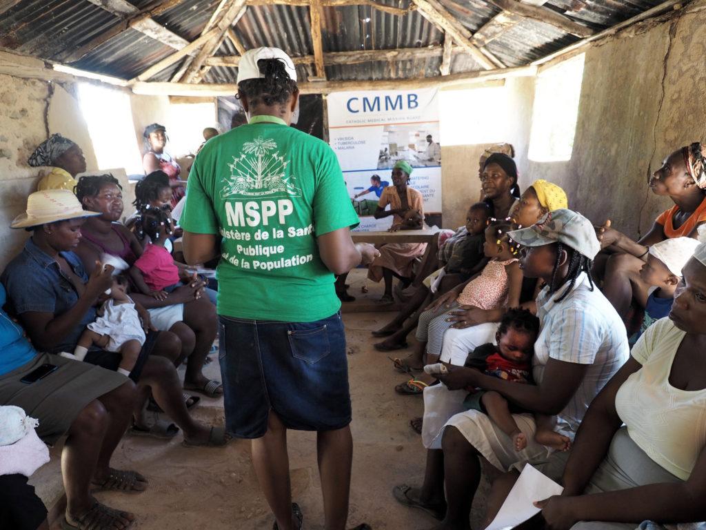 Mother's Club in session. A community health worker shares knowledge with mothers in the community.