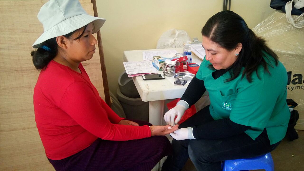 Nurse Maritza checking hemoglobin levels for a pregnant mother in Huancayo in a pop-up quarterly clinic