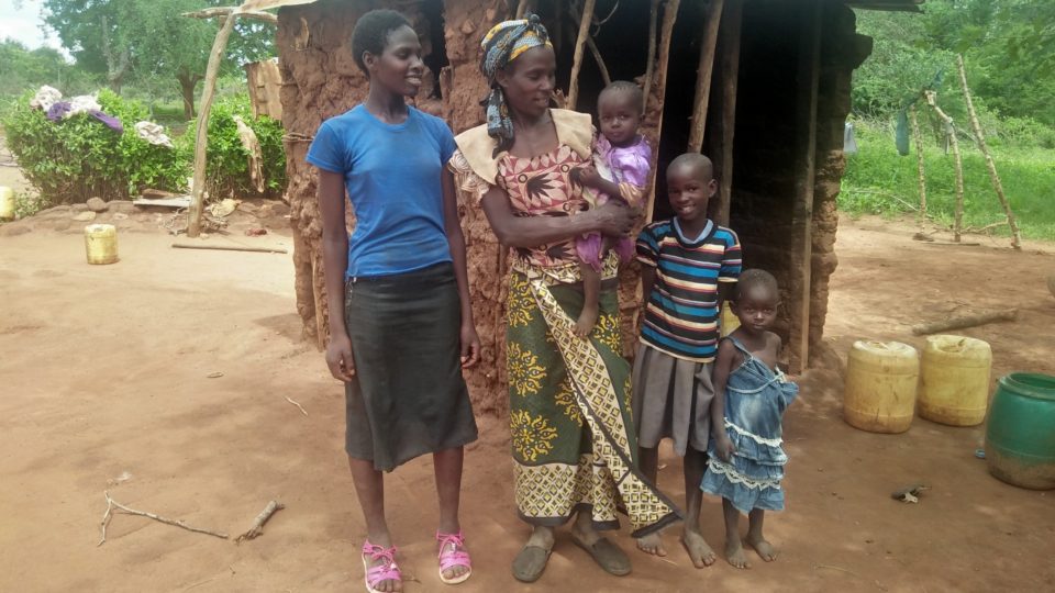 Lilian, her mother and her siblings. All standing outside their home