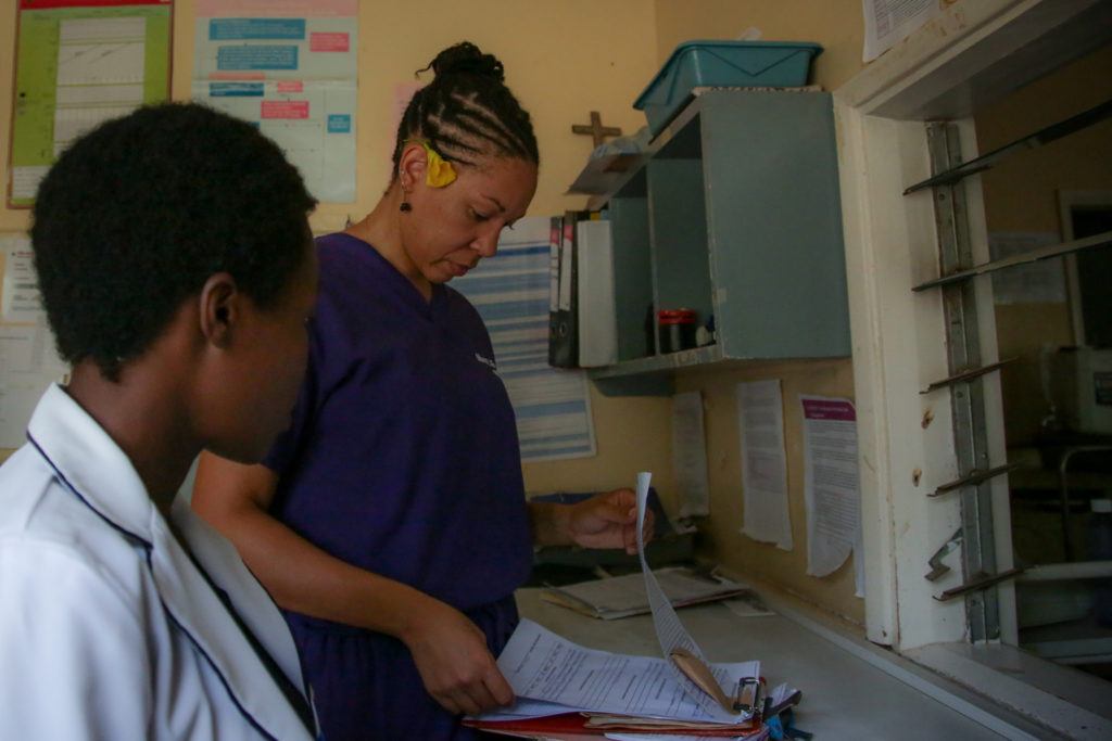 Mary at the hospital with a local Kenyan