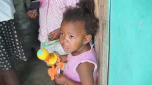 Francesca at her home in Haiti with her older sister, Laurie.