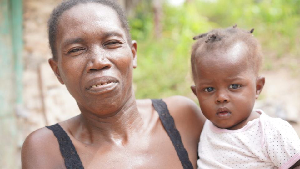 Jean Ali being held by her mom, Lorina, in Haiti.