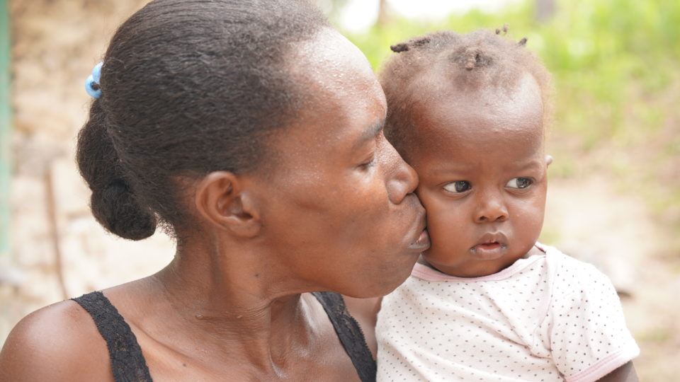 Jean Ali receives a loving kiss from her mom.