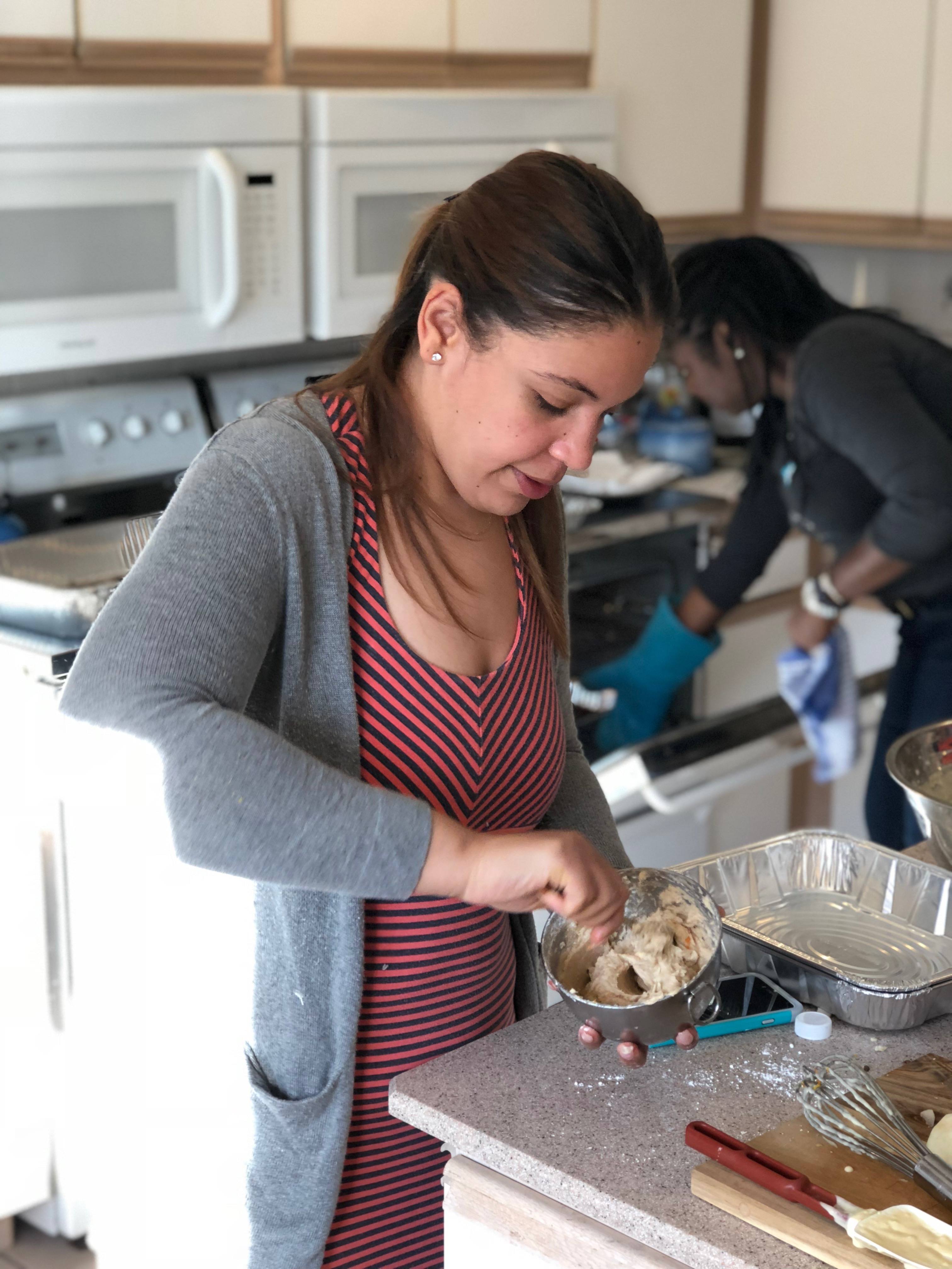 Photo of intern Mabel Almanzar cooking.