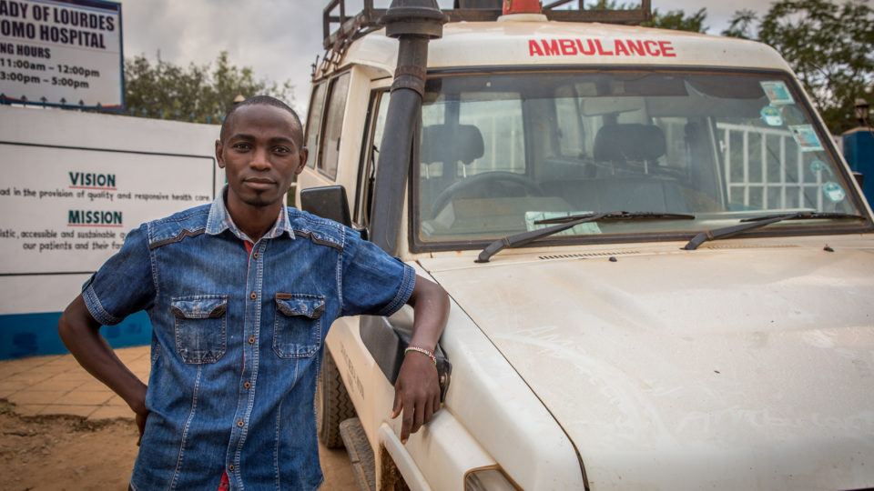 Robert standing next to the ambulance he drives