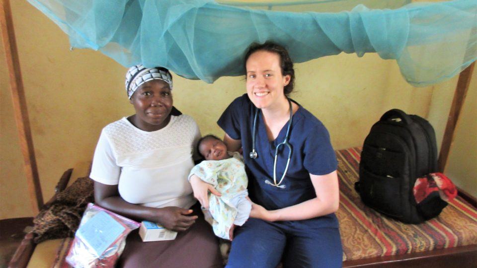 Sarah Rubino holding the newborn baby helped safely deliver