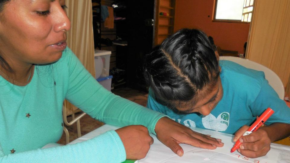 Leslie completing a therapy activity - CMMB Peru Angel