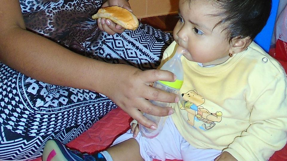  María being helped to eat - CMMB Peru Angel