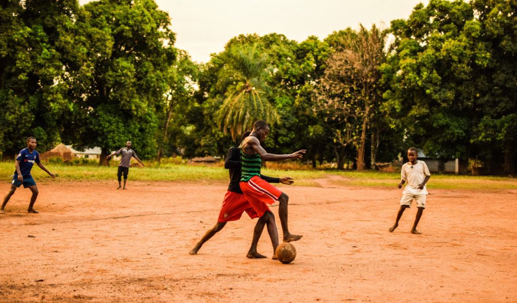 Some guys playing soccer in Nzara.