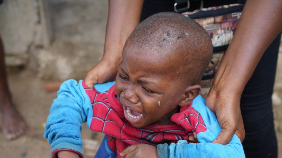 Young Rubens crying outside of his home. He was scared to meet us.