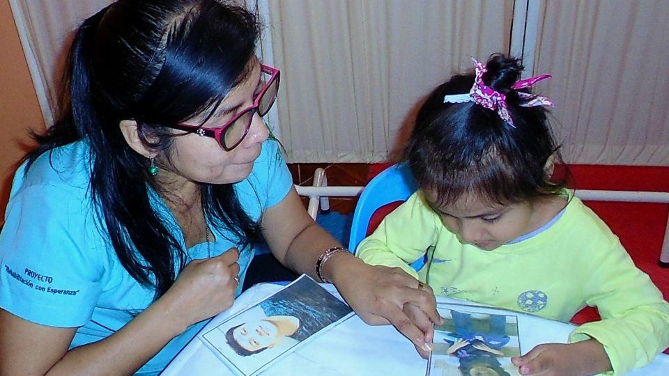 Valeria completing a therapy activity - CMMB Peru Angel