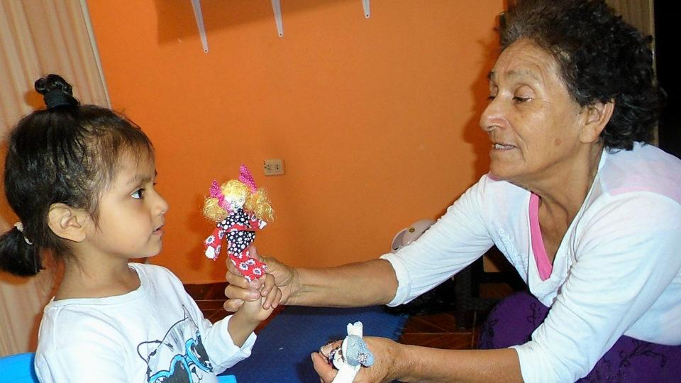 Valeria playing with a doll - CMMB Peru Angel