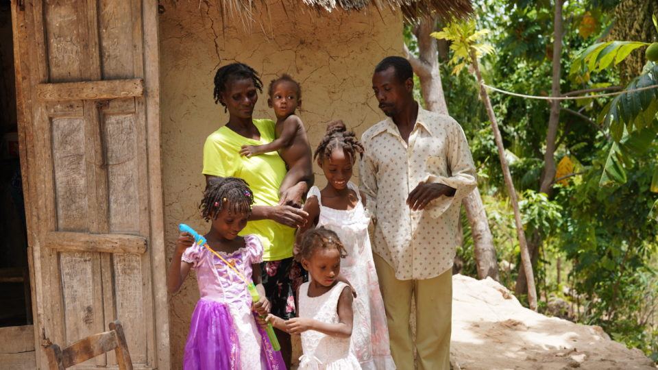 Edwidge and her family, outside their home Edwidge and her family, outside their home