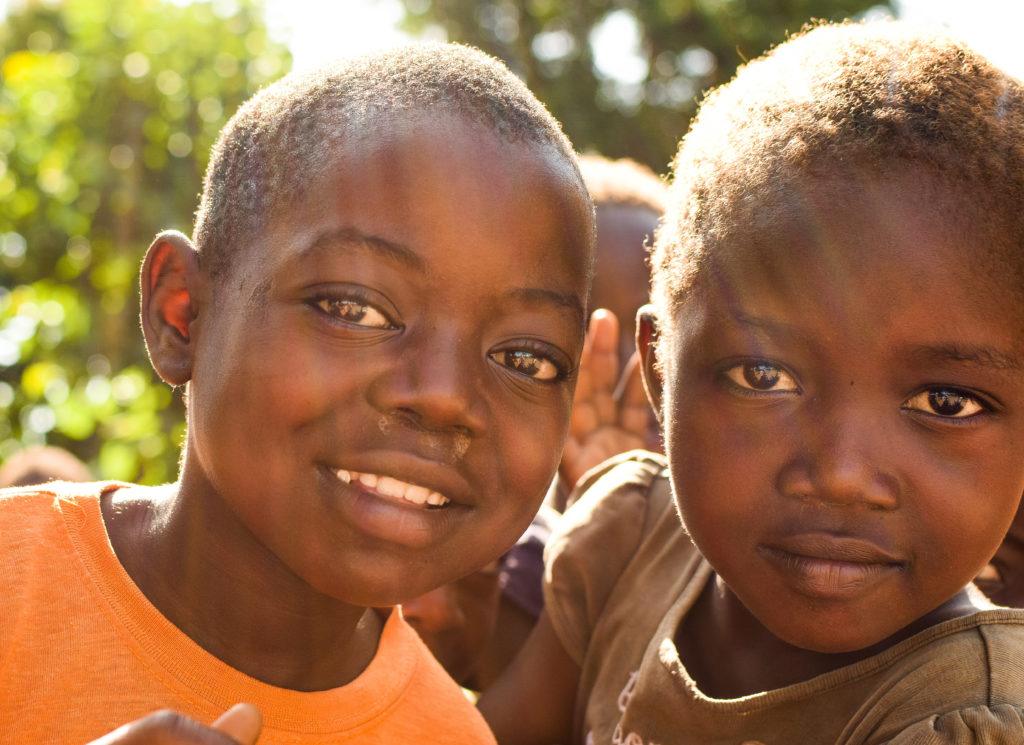 Children look into the camera. These are the faces of Yambio. 