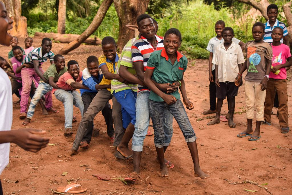 Children play a game of human tug of war. Child friendly spaces bring joy to those living in conflict. 