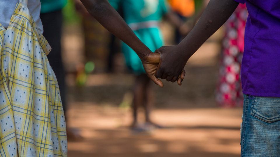 Holding on for peace. Two children hold hands during child protection activities