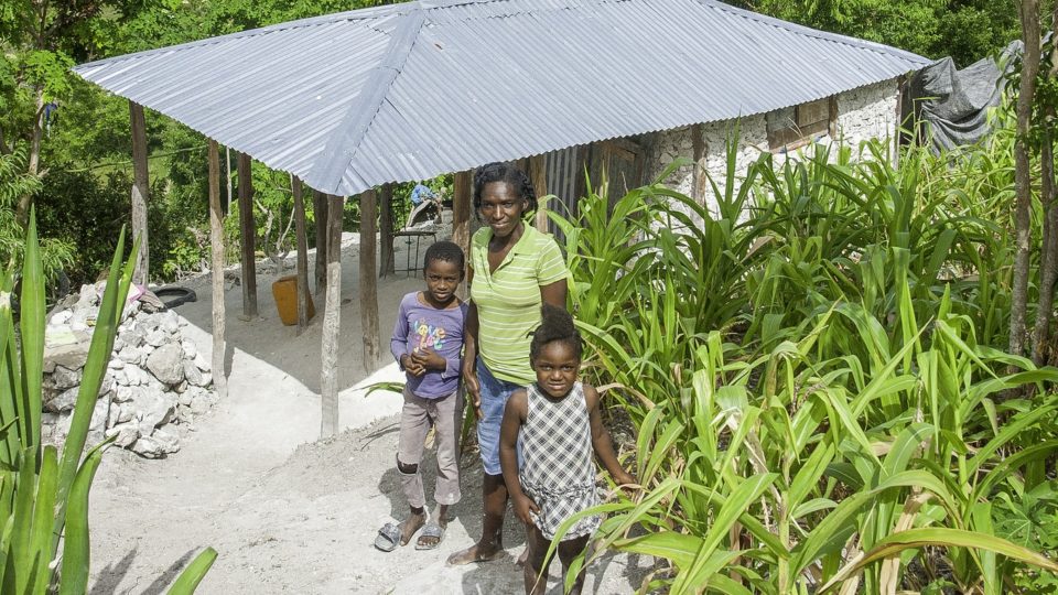 Fekey with his mother and sister, outside their home Fekey with his mother and sister, outside their home