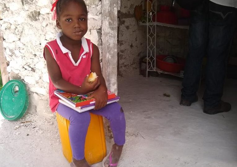 Genica is four years old Genica eating outside her home
