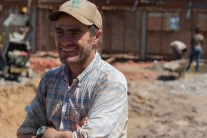 Martin Rubino, a volunteer in South Sudan, stands in front of the hospital expansion site