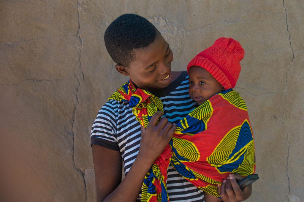 Mother holding and smiling at her child